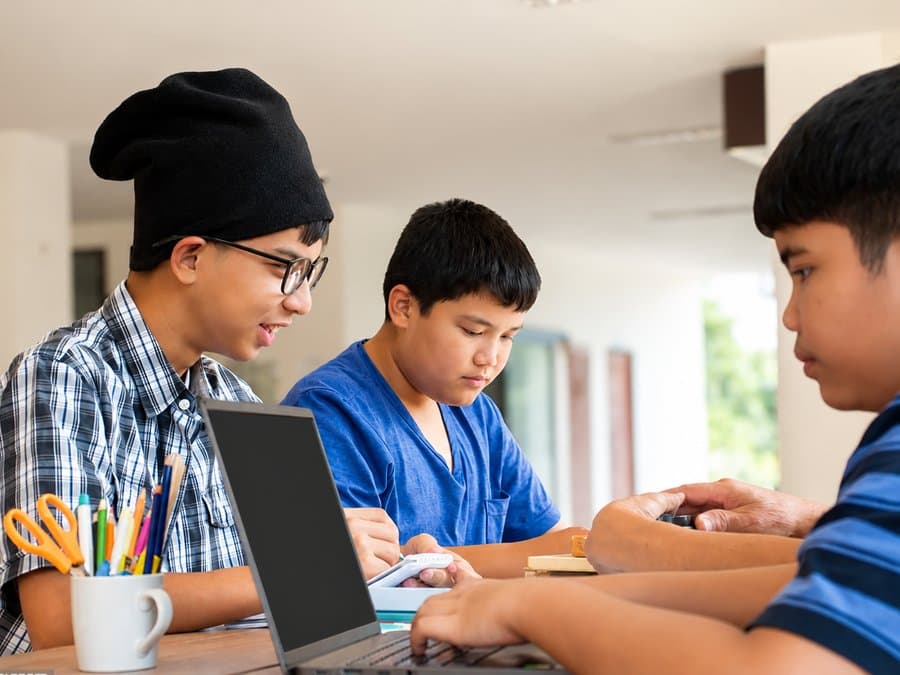A small group of students learning with a mentor