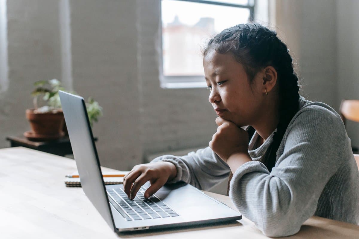 A student working through a problem on their laptop